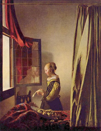Girl reading a letter at an open window